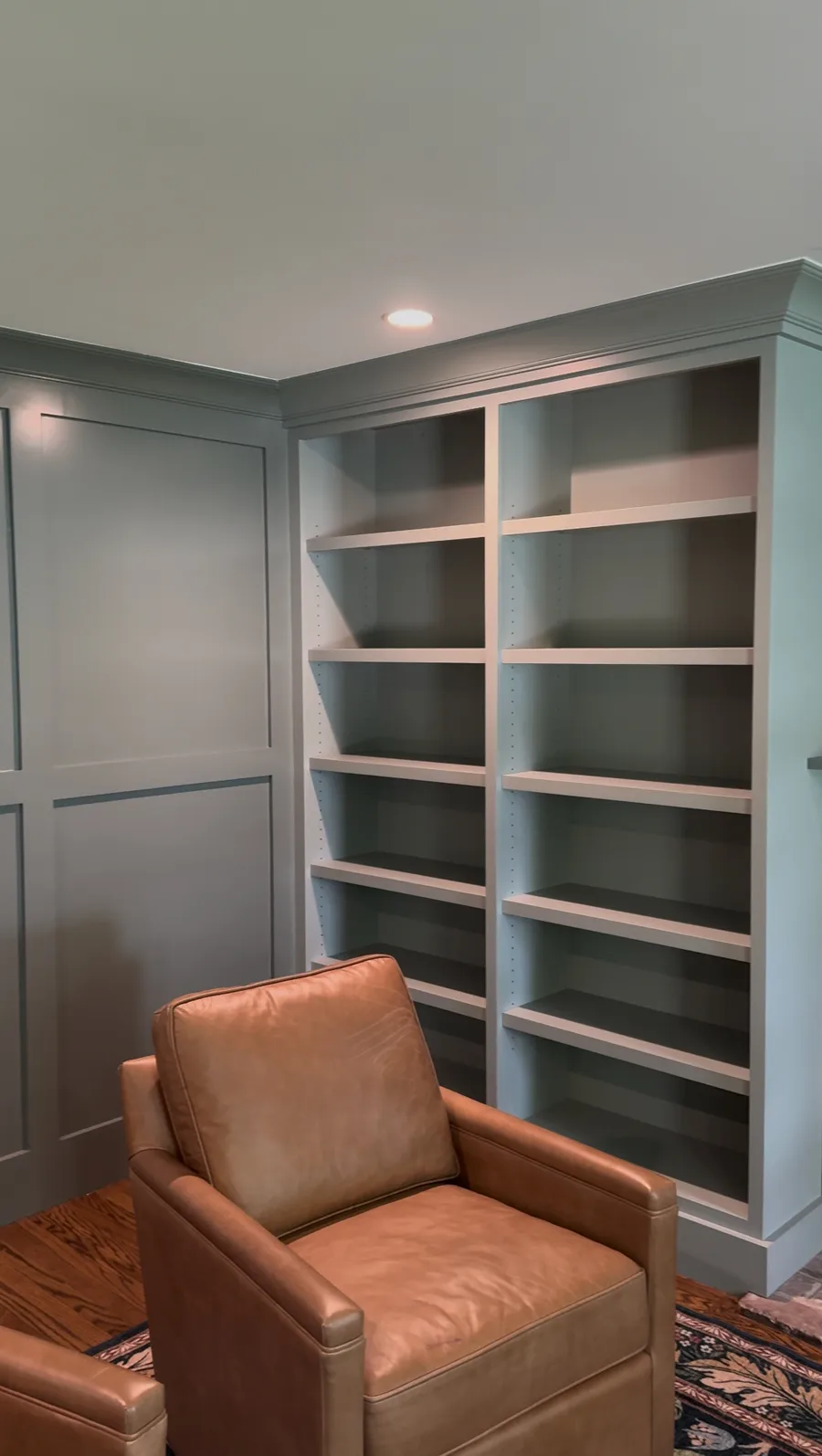 Finished built-in bookcase with leather armchair, Newtown Square family room by ProBrothers