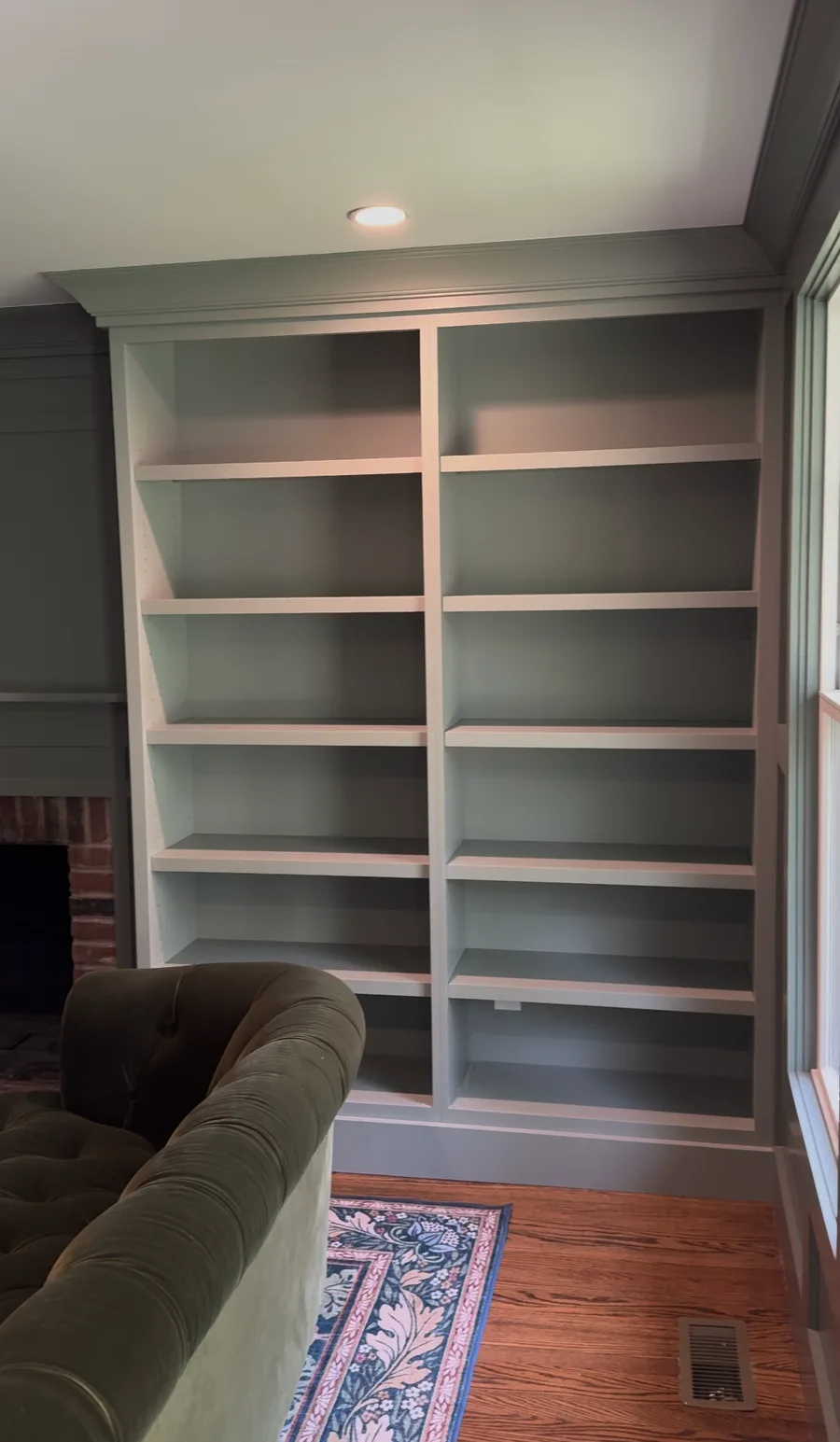 Built-in bookcase beside fireplace, completed Newtown Square family room renovation