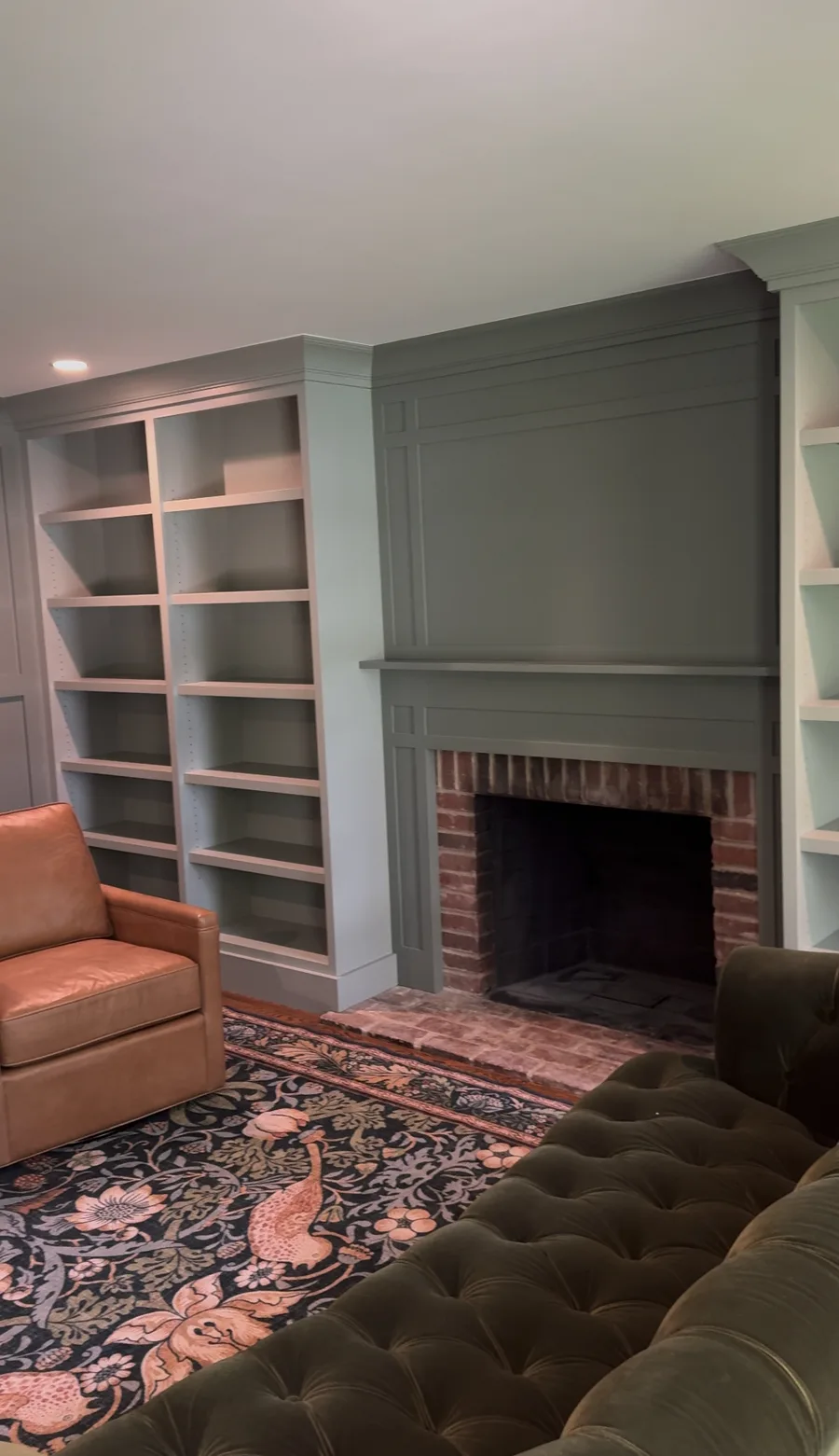 Wide view of completed family room — bookshelves, fireplace, and wall panels, Newtown Square