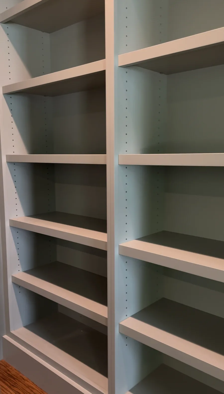 Close-up of adjustable shelves inside built-in bookcase, ProBrothers Newtown Square