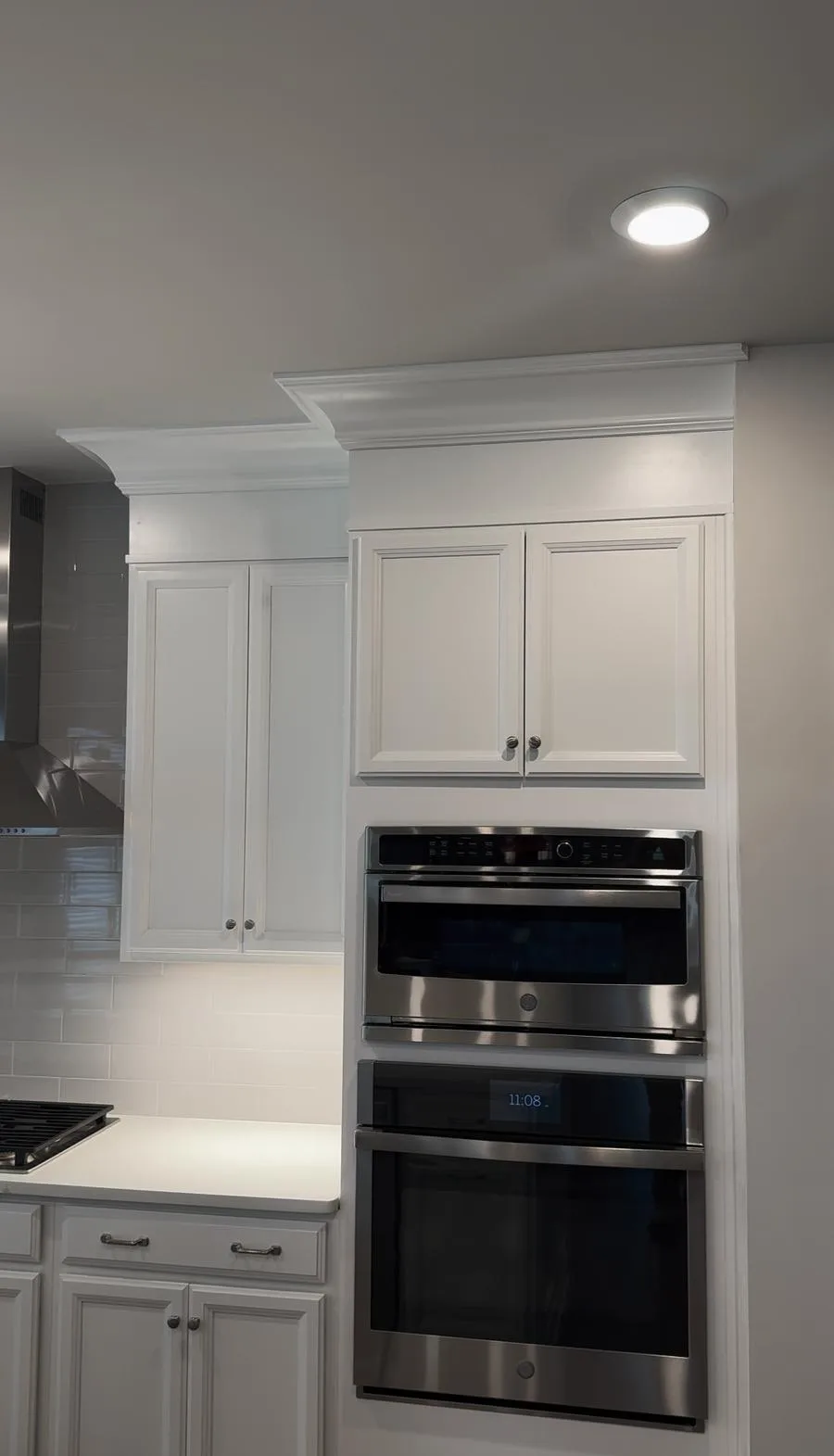 Finished oven tower and surrounding white cabinetry after West Chester kitchen renovation