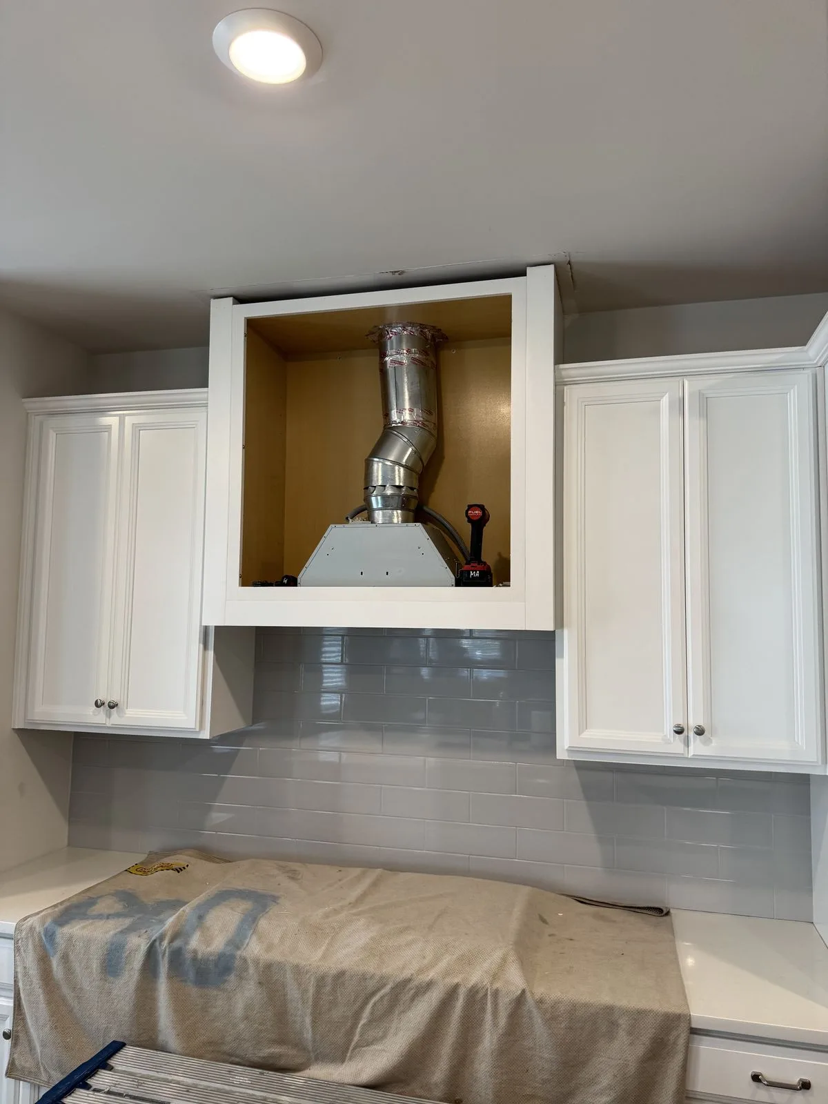 Range hood inside soffit enclosure — alternate angle during installation, West Chester kitchen